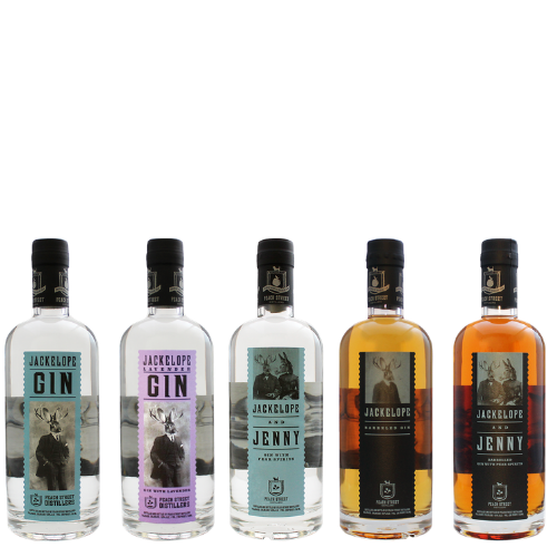 Five Jackalope Spirits bottles from Peach Street Distillers are lined up side by side. The two on the left hold clear gin, while the three on the right showcase amber spirits. Each label features a jackalope illustration and distinct text colors.
