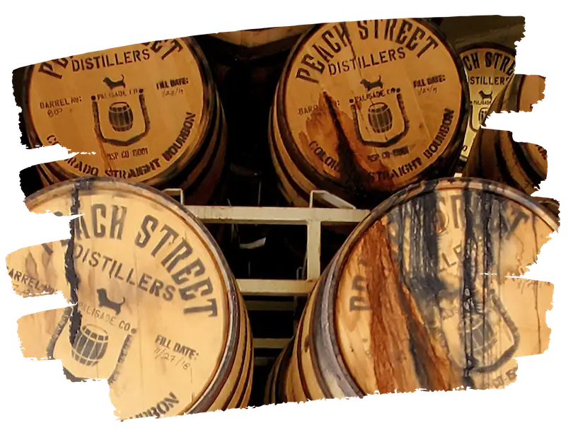 Wooden barrels labeled Peach Street Distillers, some marked 'Bourbon,' are stacked on shelves with dark liquid stains running down the sides. A painted border effect frames the image.