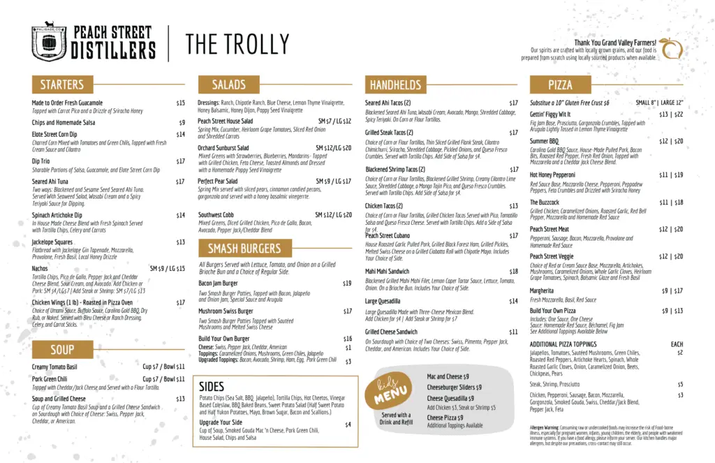 Menu from Peach Street Distillers featuring a variety of starters, soup, salads, smash burgers, sides, handhelds, and pizza. The menu includes dish names, descriptions, prices, and dietary symbols for gluten-free and vegetarian options.